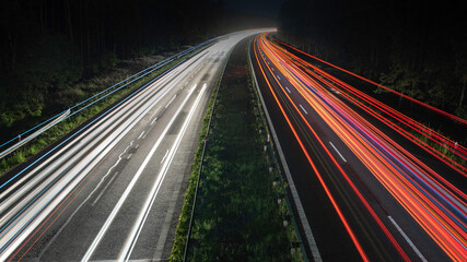 Fototapeta na wymiar Truck light trails on highway. Art image . Long exposure photo taken on a highway