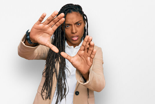 African american woman wearing business jacket doing frame using hands palms and fingers, camera perspective