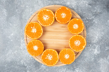 Sliced juicy fresh orange fruits in a wooden plate