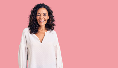 Middle age beautiful woman wearing casual sweater winking looking at the camera with sexy...