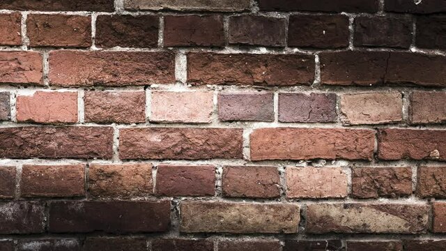 Zooming  red brick wall texture background. In motion brick wall of an loft style building.