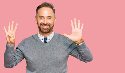 Fototapeta premium Handsome middle age man wearing business clothes showing and pointing up with fingers number nine while smiling confident and happy.