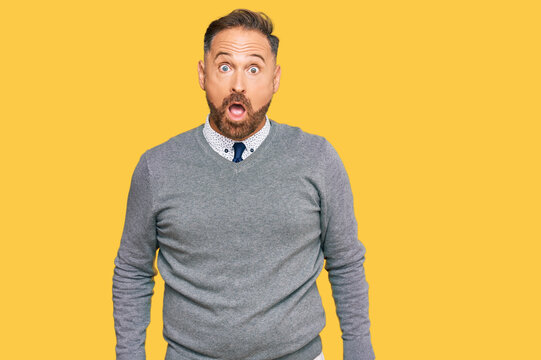 Handsome middle age man wearing business clothes afraid and shocked with surprise and amazed expression, fear and excited face.