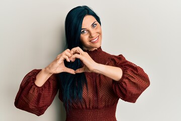 Young caucasian woman wearing casual clothes smiling in love doing heart symbol shape with hands. romantic concept.