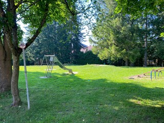 Playground with lawn and trees