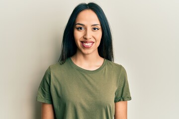 Fototapeta premium Young hispanic girl wearing casual t shirt with a happy and cool smile on face. lucky person.