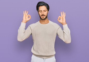 Naklejka premium Young hispanic man wearing casual clothes relax and smiling with eyes closed doing meditation gesture with fingers. yoga concept.