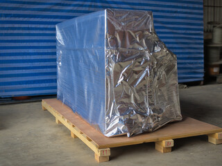 Packed and wrapped goods on top of wooden palette ready for delivery