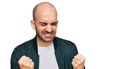 Young hispanic man wearing casual clothes very happy and excited doing winner gesture with arms raised, smiling and screaming for success. celebration concept.