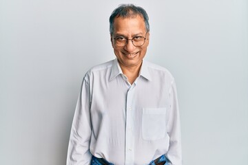 Middle age indian man wearing casual clothes and glasses with a happy and cool smile on face. lucky person.