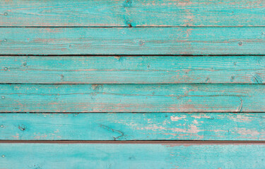Wooden background, old wooden wall, painted blue, with slits and nails.