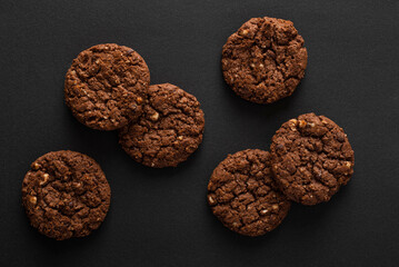 Brown chocolate cookies on dark background
