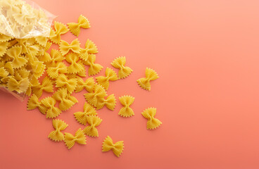Pasta farfalle on pink background