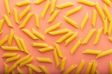 Pasta penne on pink background