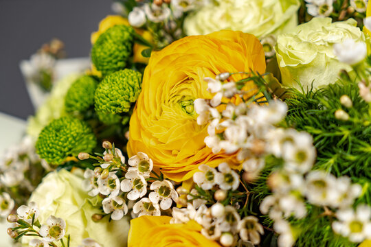 Yellow bouquet of yellow and orange flowers on grey background