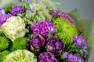 Bouquet of pink roses, alstroemeria flowers and orchids. Fresh summer flowers against gray background