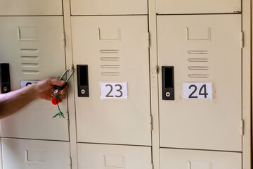 A hand with a locker key Numbered lockers For safety