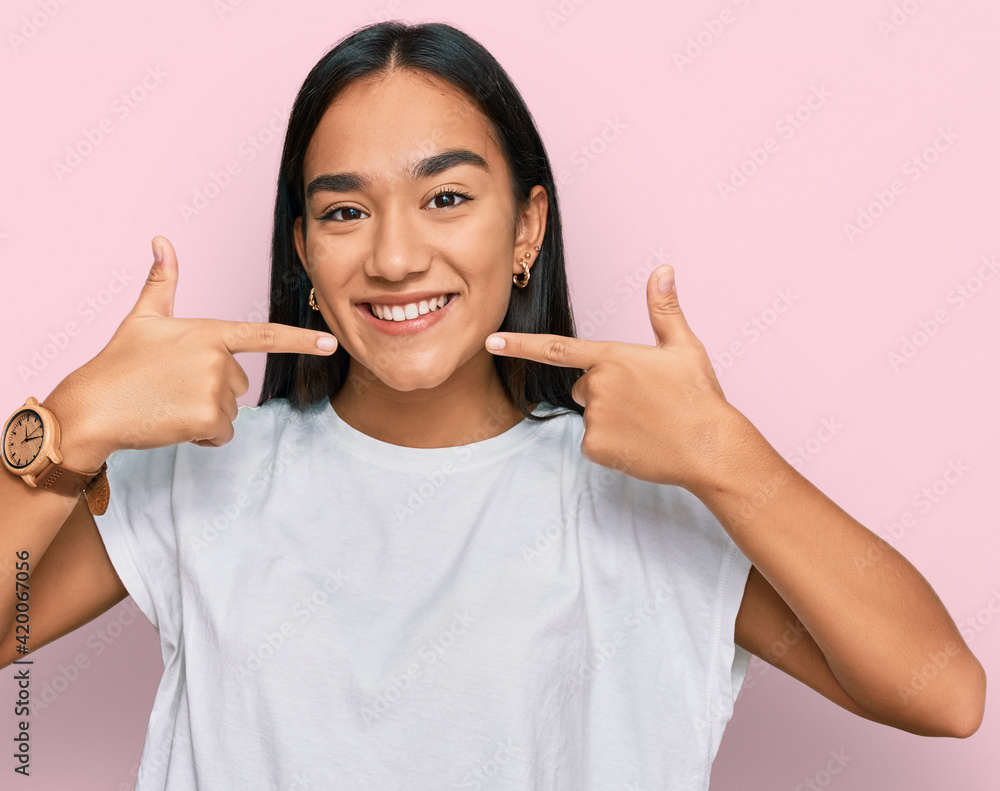 Poster young asian woman wearing casual white t shirt smiling cheerful showing and pointing with fingers te