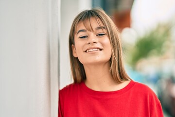 Caucasian teenager girl smiling happy standing at the city.