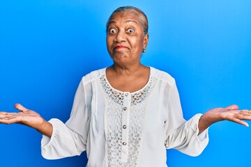 Senior african american woman wearing casual clothes clueless and confused with open arms, no idea...