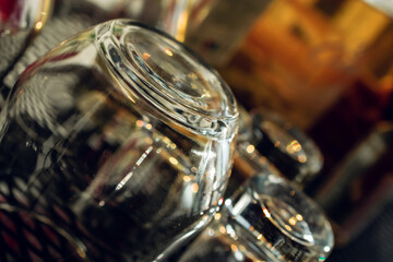Empty alcohol glasses in front of blurry background