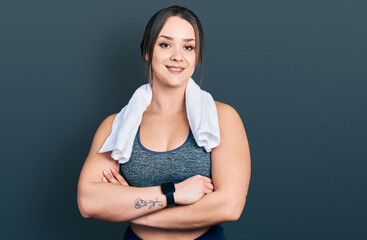 Obraz premium Young hispanic girl wearing sportswear and towel happy face smiling with crossed arms looking at the camera. positive person.
