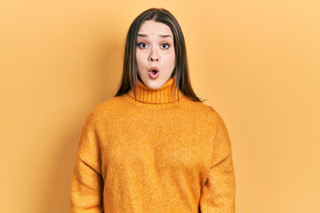 Young hispanic girl wearing casual clothes afraid and shocked with surprise expression, fear and excited face.