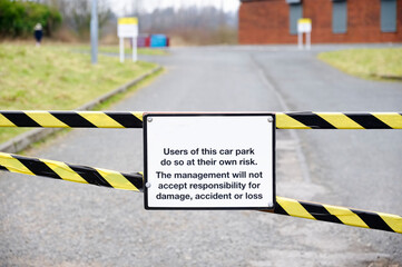 Car park users do so at own risk sign