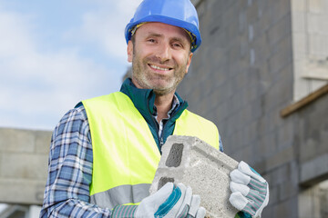 the master in gloves lays paving stones in layers