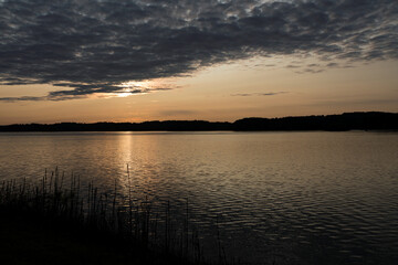 Fototapeta na wymiar Clearing Clouds at Sunrise Dawn on Tranquil Lake