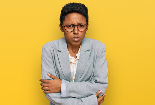 Young african american woman wearing business clothes shaking and freezing for winter cold with sad and shock expression on face