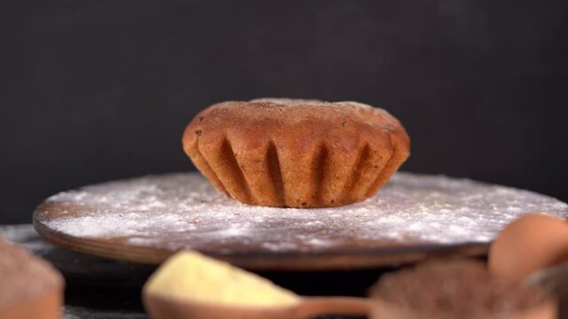 fresh baked cornbread rotating with a wooden cutting board, side view. Copy space. home baking concept.