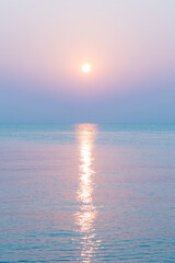 Amazing sunset over the beach. The sun rises over sea.  Pastel tone