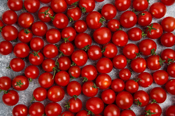 Red cherry tomatoes on marblegrey background