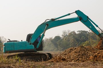 Cyan Excavators are digging the soil in the construction site location field