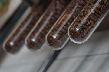 Coffee bean in the glass tube Selective focus Front