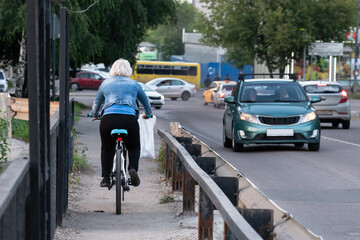 Old lady riding bike in park