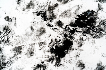 Black blots and spots on a white background.