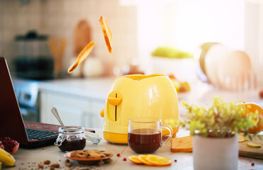 Close up photo of fresh tasty slices of toasts from the yellow toaster on the beautiful kitchen table at home
