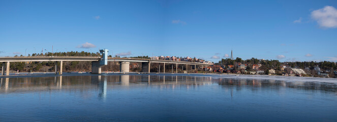 Long bridge at district Nockeby in Stockholm and a partial frozen lake Mälaren a sunny winter day.