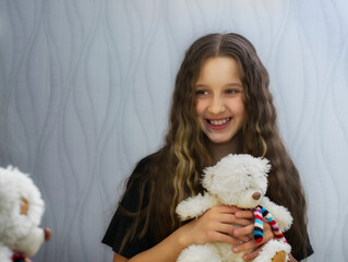 Young beautiful girl posing in front of the camera with her curly hair.