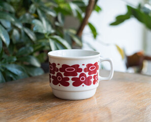 Mid century modern cups with purple flowers pattern on a wooden table