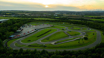 Aerial drone view of a go kart car race track circuit at sunset
