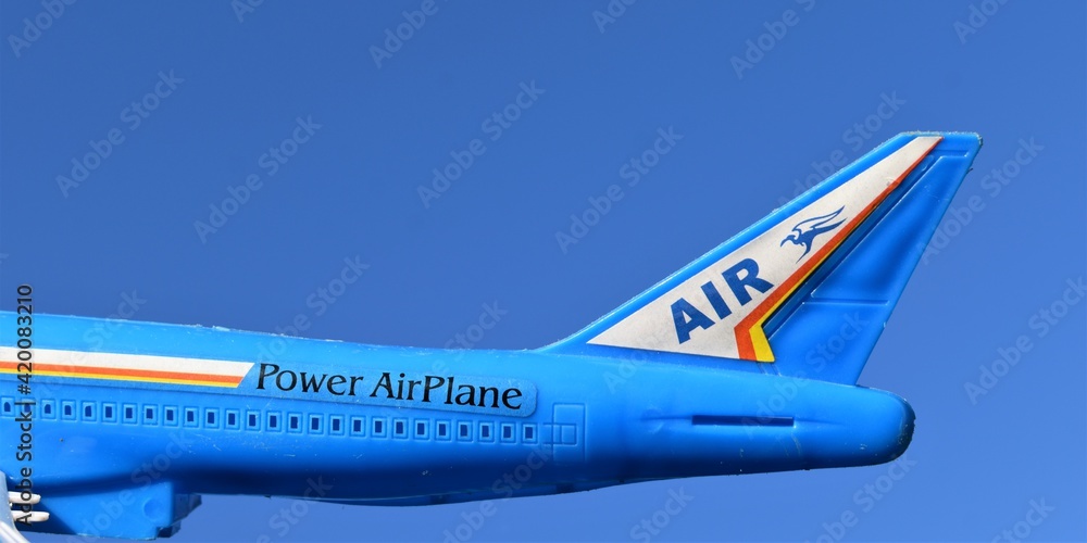 Wall mural plastic toy plane isolated on a sky background. power airplane.