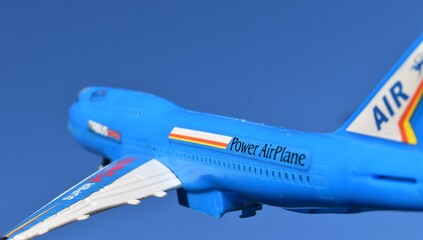 plastic toy plane isolated on a sky background. Power airplane. 