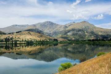 Fototapeta na wymiar Mountains reflection on the lake surface, nature background