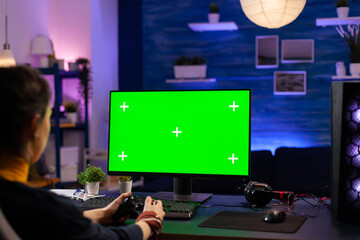 Competitive gamer looking into powerful pc with green screen display playing online games for live...