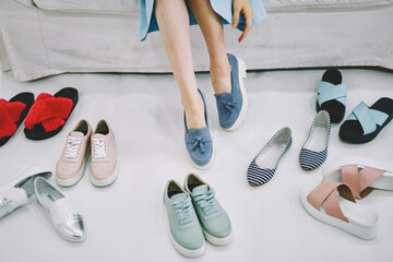 Woman trying on blue moccasins
