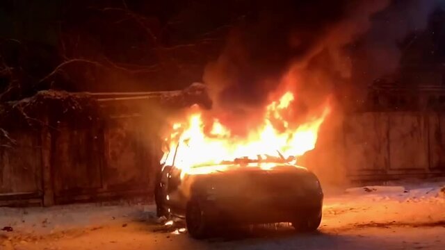 A car spews fire as it burns violently