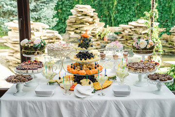 Dessert table for a party. Ombre cake, cupcakes, sweetness.